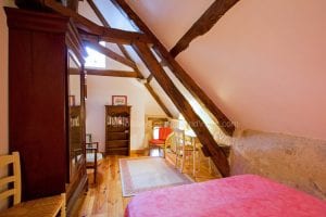 Le Moulin master bedroom with lovely oak beams
