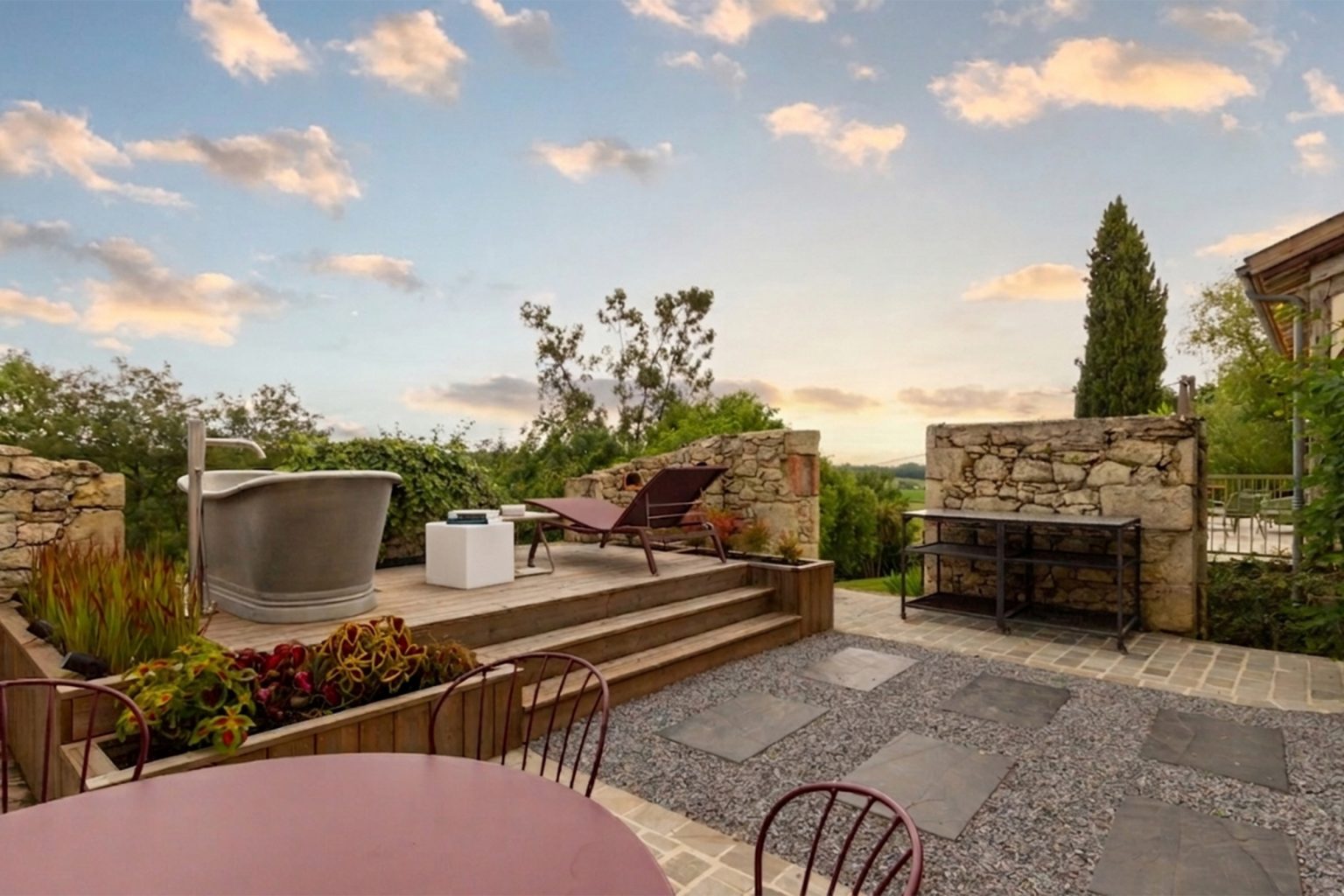 The feature exterior bath and what a view, ideal to watch the sunset at Blanchet luxury holiday home in Southwest France, overlooking the rolling valley views between Bordeaux and Bergerac
