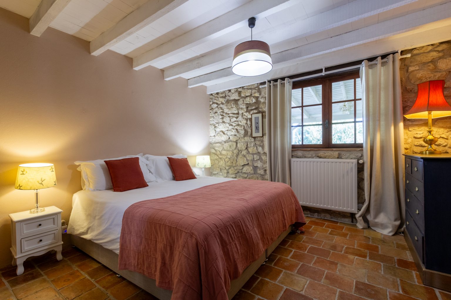 Bedroom 1 looks out towards the pool, upper floor