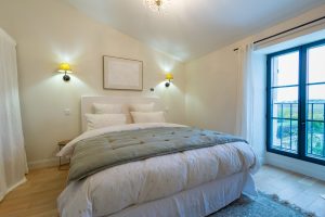 Bedroom 1, there is clothes hanging and drawers to the left