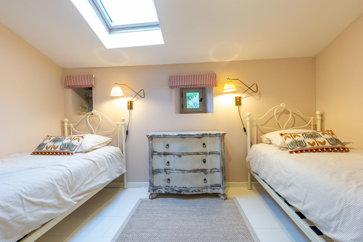 Twin bedroom on the upper floor at Blanchet holiday home in Southwest France, showing two single beds with a view towards the private shower room opposite.