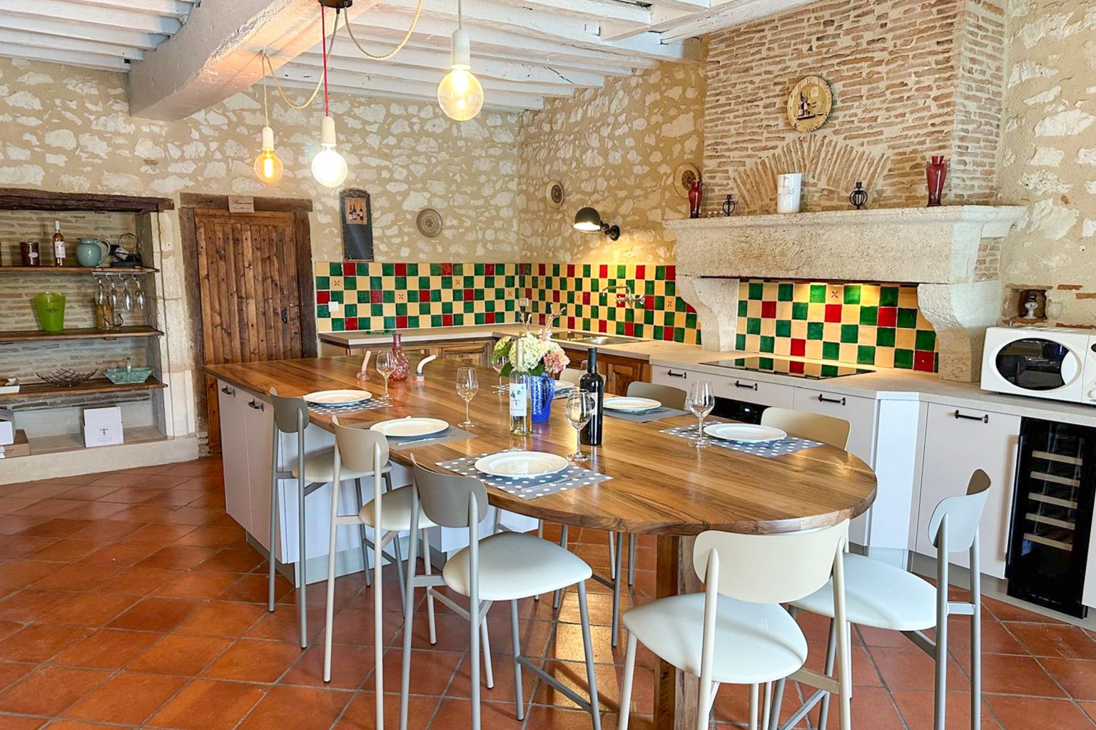 Dining table and the kitchen at Jubin, 5 bedroom villa with a secure private pool