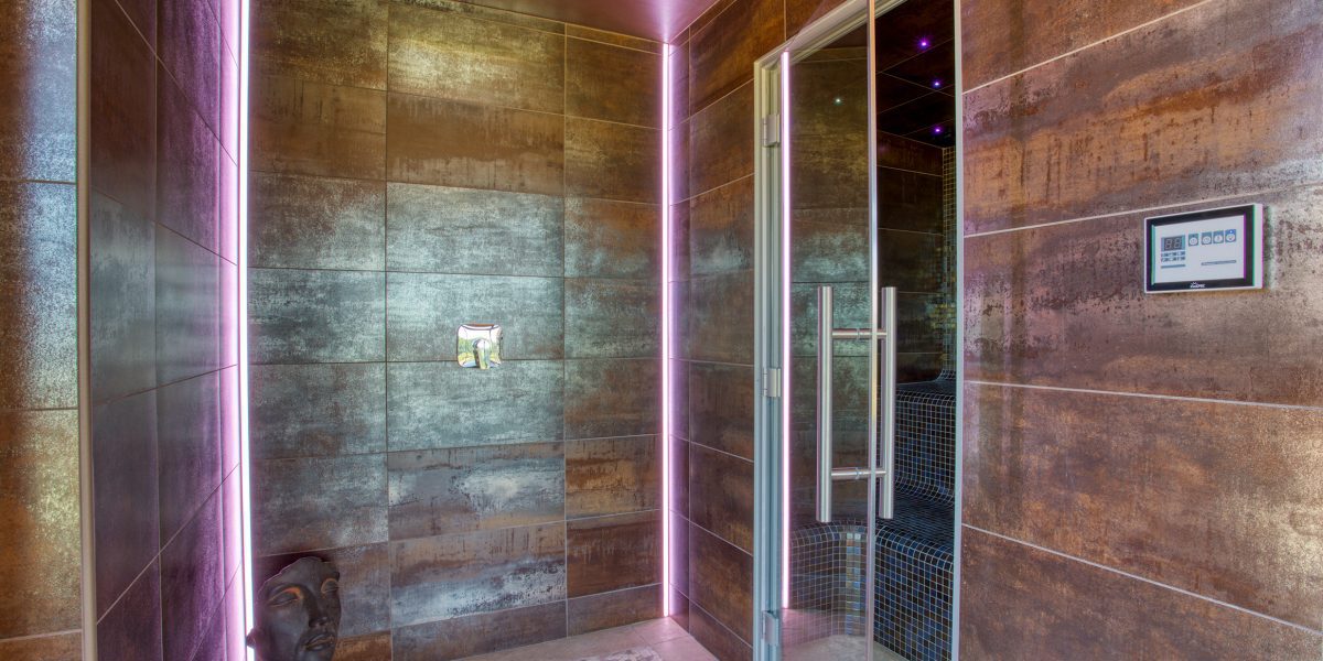 In the Spa room is a hot tub, walk in shower and the Hamman steam room, to the left leads outside to the sauna pod