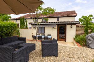 Les Oliviers outside dining table and a shaded seating area
