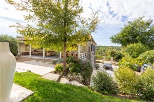 Looking down to the driveway and lower terrace where there is an entrance to the lower floor
