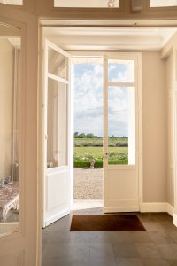 Looking out from the back of the chateau to a lawn and vines, Château de Bel Air, Lalande-de-Pomerol near Bordeaux, France