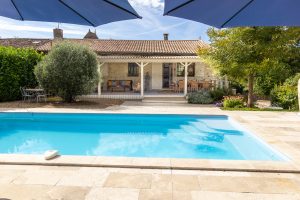 Looking to the house, covered dining and seating are is just outside from the kitchen