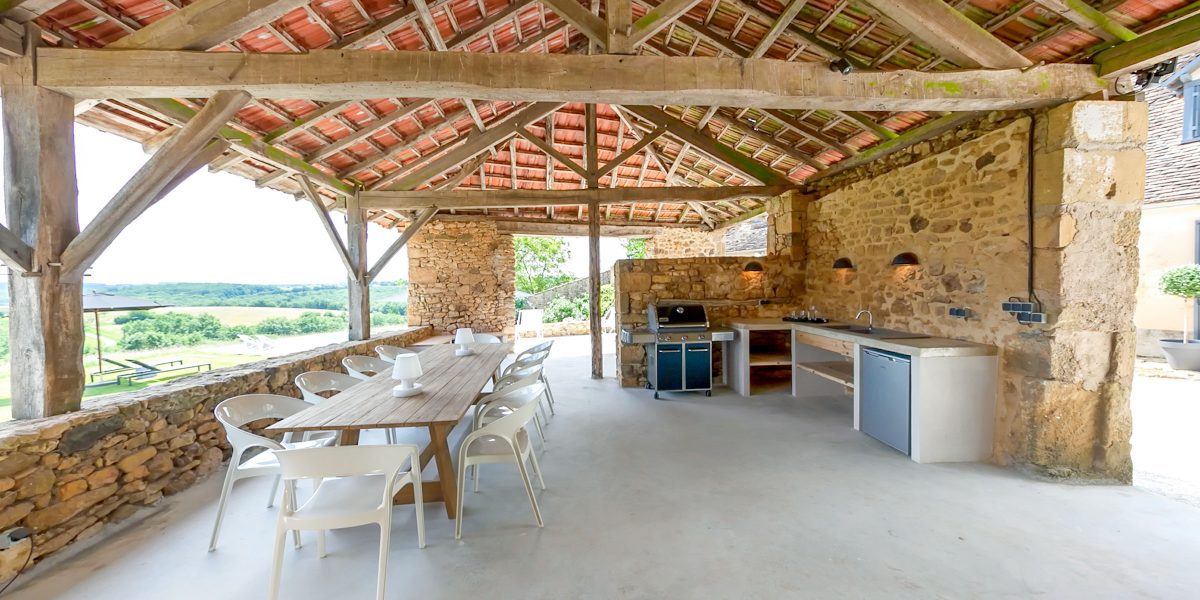 Shaded and covered summer kitchen and dining area with stunning hilltop views