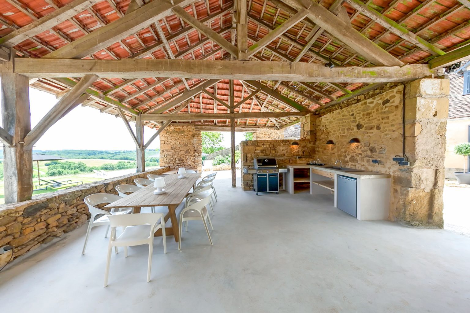 Shaded and covered summer kitchen and dining area with stunning hilltop views