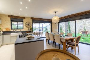 Open plan kitchen and dining area looking out to the pool and the valley below