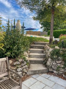 Steps up to the back garden and the pool