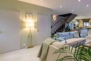 The door to the left is the utility room with a washing machine and dryer, the other is the WC