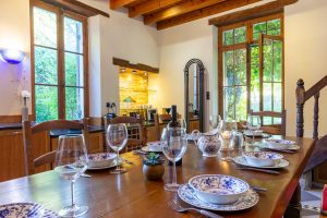 The kitchen door opens out towards the pool area and exterior dining table