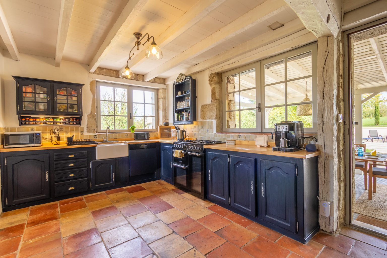 The kitchen looking out to the covered dining area and to the pool