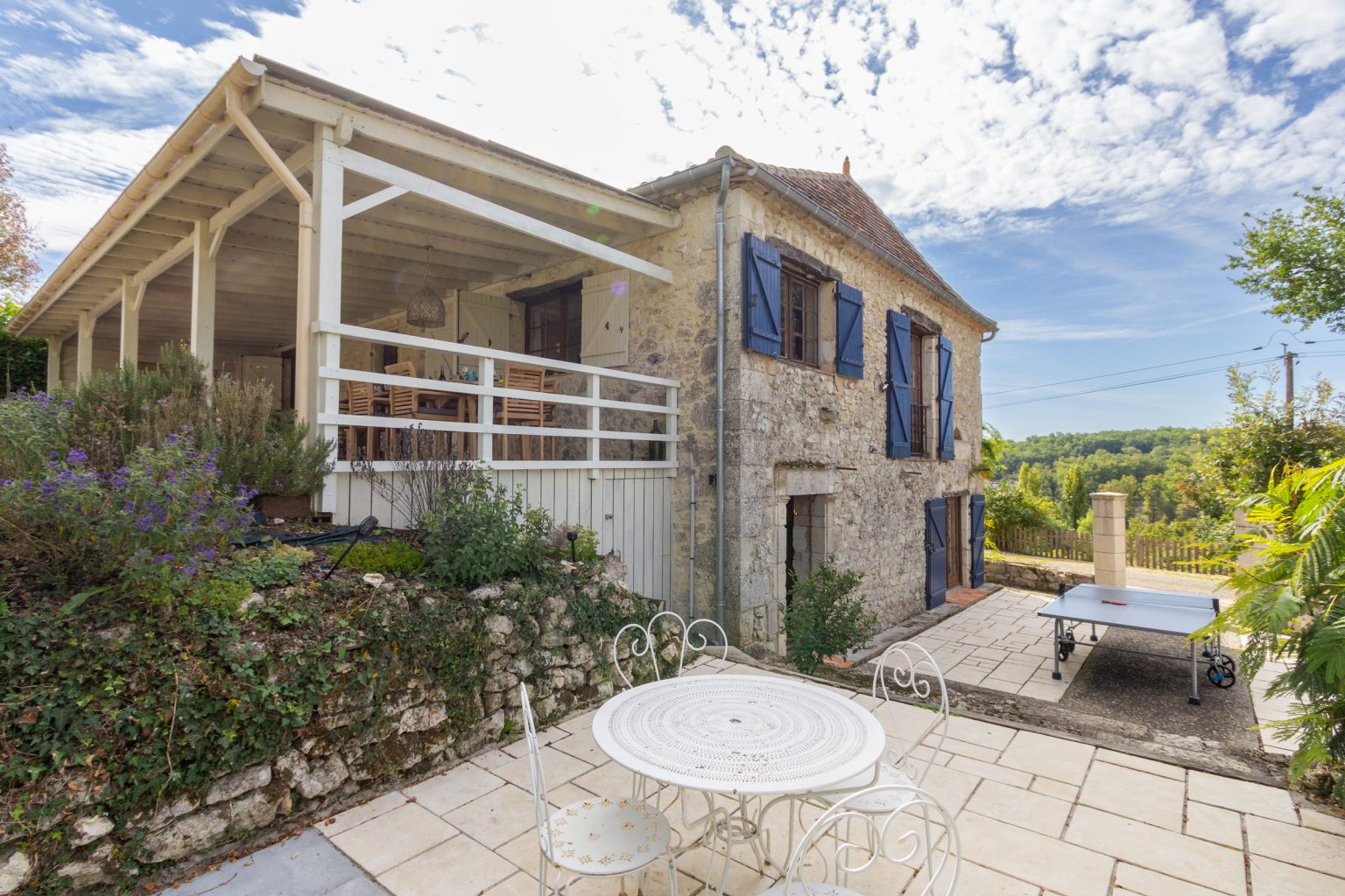 The side of the house, parking for 2 cars on the driveway is to the right, further parking is to the front of the house