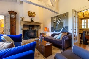 The sitting room, left is into the dining room, right takes you towards the kitchen, the staircase takes you to the lower floor